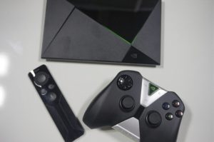 The Nvidia Shield microconsole with remote and gamepad.